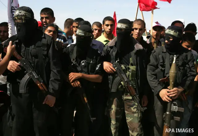 Hamas militants celebrate the release of prisoners at the Rafah border crossing in southern Gaza Strip, Tuesday, Oct. 18, 2011. Tens of thousands of flag-waving Palestinians on Tuesday celebrated the homecoming of hundre...