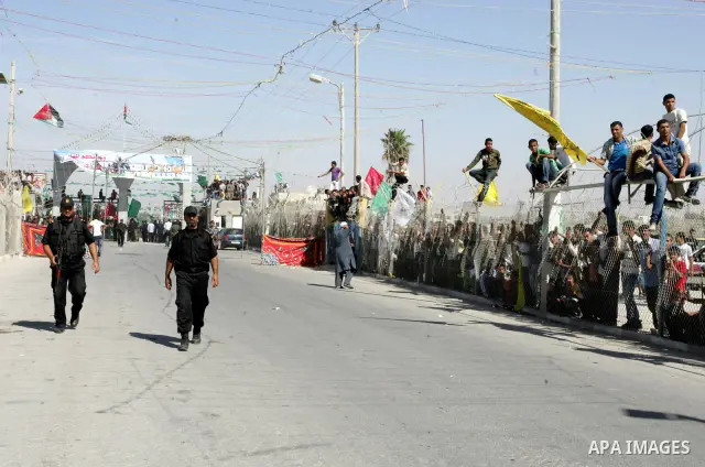 Palestinian youths celebrate the release of prisoners at the Rafah border crossing in southern Gaza Strip, Tuesday, Oct. 18, 2011. Tens of thousands of flag-waving Palestinians on Tuesday celebrated the homecoming of hun...