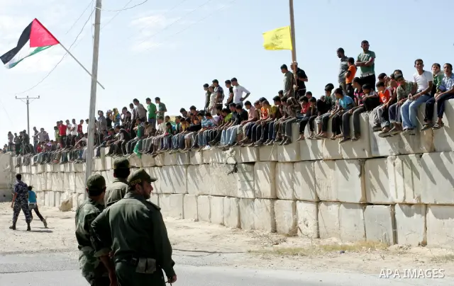 Palestinian youths celebrate the release of prisoners at the Rafah border crossing in southern Gaza Strip, Tuesday, Oct. 18, 2011. Tens of thousands of flag-waving Palestinians on Tuesday celebrated the homecoming of hun...