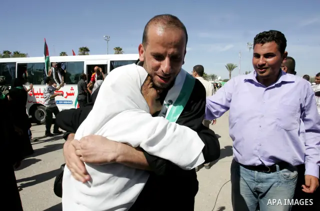 Palestinians greet their relative released Palestinian prisoner at the Rafah border crossing in southern Gaza Strip, Tuesday, Oct. 18, 2011. The Hamas militant group released an Israeli soldier Tuesday more than five yea...