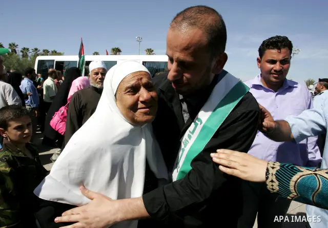 Palestinians greet their relative released Palestinian prisoner at the Rafah border crossing in southern Gaza Strip, Tuesday, Oct. 18, 2011. The Hamas militant group released an Israeli soldier Tuesday more than five yea...