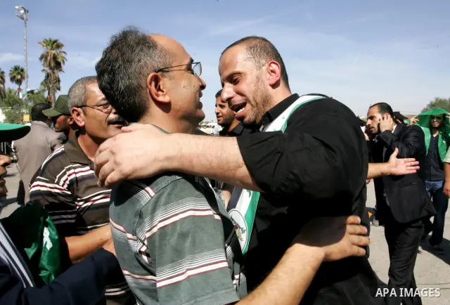 Palestinians greet their relative released Palestinian prisoner at the Rafah border crossing in southern Gaza Strip, Tuesday, Oct. 18, 2011. The Hamas militant group released an Israeli soldier Tuesday more than five yea...
