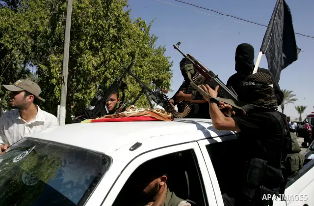 Hamas militants celebrate the release of prisoners at the Rafah border crossing in southern Gaza Strip, Tuesday, Oct. 18, 2011. Tens of thousands of flag-waving Palestinians on Tuesday celebrated the homecoming of hundre...