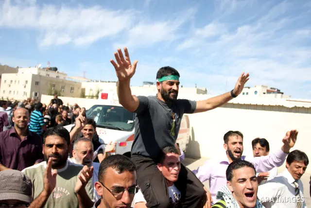 A Palestinian prisoner is welcomed by a crowd following the release of hundreds of prisoners from Israeli jails on October 18,2011 at the Palestinian Authority headquarters in the West Bank city of Ramallah. Crowds of Pa...