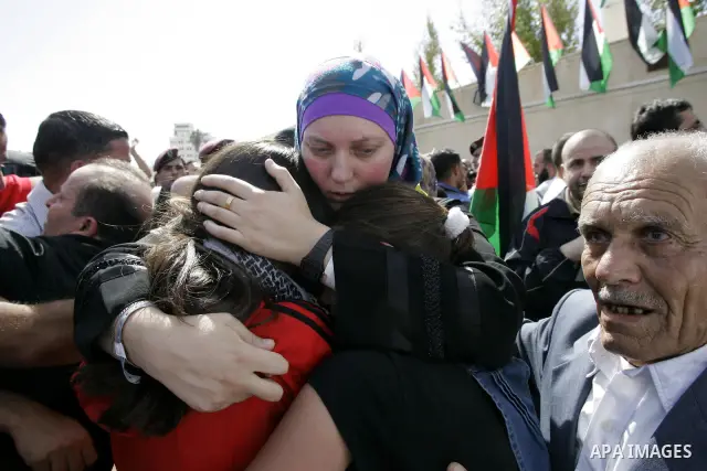 A released Palestinian prisoner is welcomed by relatives in the West Bank city of Ramallah, Tuesday, Oct. 18, 2011. Hamas agreed to release Israeli soldier Galit Schalit in exchange for 1,027 Palestinian prisoners, many...