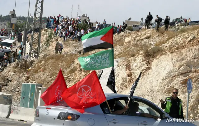 Palestinians wait for former prisoners to be released in East Jerusalem from Israeli prison, Tuesday, Oct. 18, 2011. Hamas agreed to release Israeli soldier Galit Schalit in exchange for 1,027 Palestinian prisoners, many...