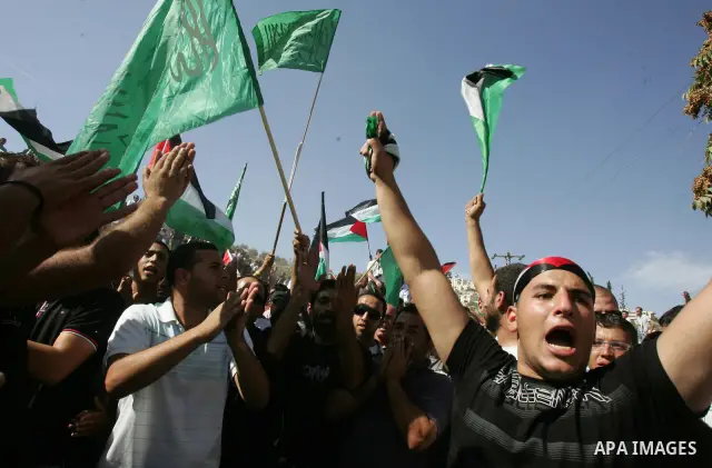 Palestinians wait for former prisoners to be released in East Jerusalem from Israeli prison, Tuesday, Oct. 18, 2011. Hamas agreed to release Israeli soldier Galit Schalit in exchange for 1,027 Palestinian prisoners, many...