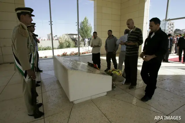 Released Palestinian prisoners read Holy Koran at the tomb of the late Palestinian President Yasser Arafat in the West Bank city of Ramallah, Tuesday, Oct. 18, 2011. Hamas agreed to release Israeli soldier Galit Schalit...