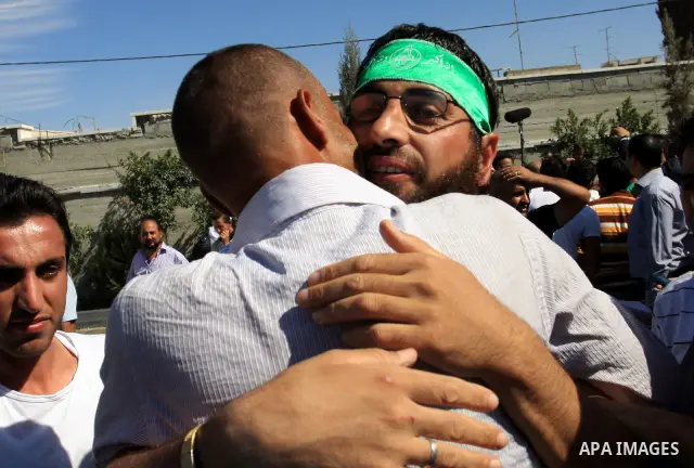 Freed Palestinian prisoners are welcomed home by their friends and relatives upon their arrival in Ramallah, the West Bank, 18 October 2011. 477 Palestinian prisoners were freed on 18 October 2011 in exchange for the rel...