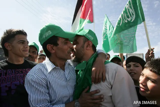 Newly released Palestinian prisoner Issam Shawish (R) waves flags as he is carried by greeters in the Arab east Jerusalem neighbourhood of Ras al-Amud October 18, 2011. Israeli soldier Gilad Shalit and hundreds of Palest...