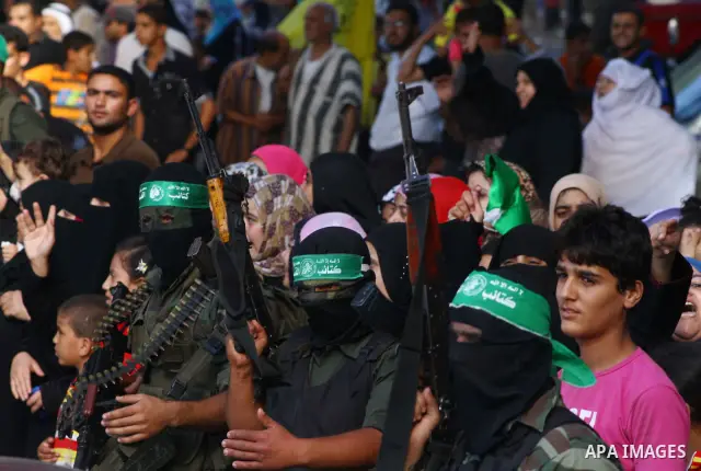 Hamas militants stand guard near Rafah Crossing through which Palestinian prisoners going to be freed in a prisoner swap between Hamas and Israel will enter the Gaza Strip on 18 October 2011 As Gilad Shalit, the Israeli...