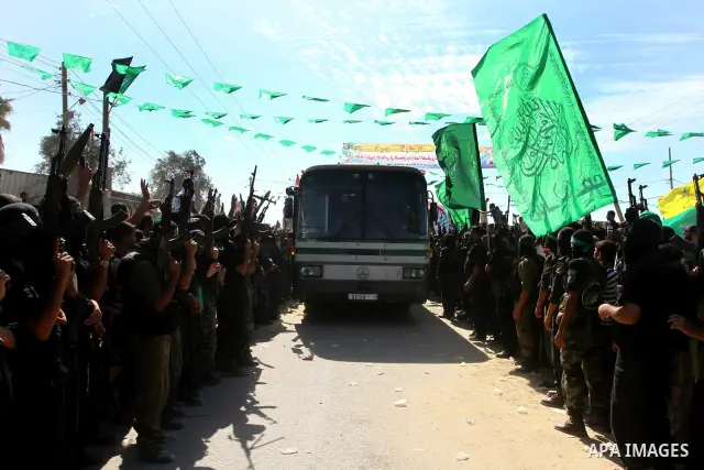 Hamas militants stand guard near Rafah Crossing through which Palestinian prisoners going to be freed in a prisoner swap between Hamas and Israel will enter the Gaza Strip on 18 October 2011 As Gilad Shalit, the Israeli...