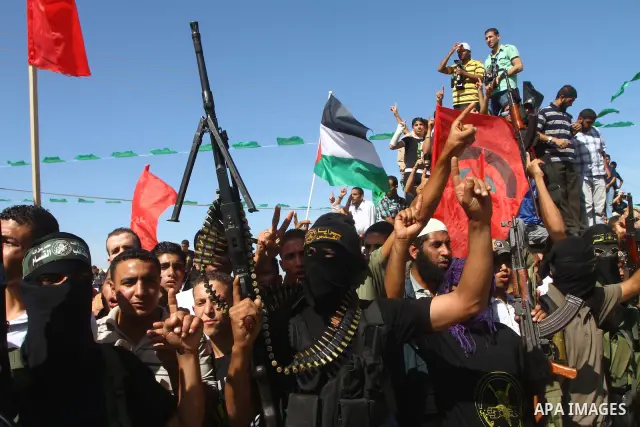 Hamas militants stand guard near Rafah Crossing through which Palestinian prisoners going to be freed in a prisoner swap between Hamas and Israel will enter the Gaza Strip on 18 October 2011 As Gilad Shalit, the Israeli...