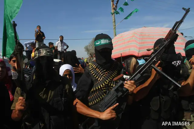 Hamas militants stand guard near Rafah Crossing through which Palestinian prisoners going to be freed in a prisoner swap between Hamas and Israel will enter the Gaza Strip on 18 October 2011 As Gilad Shalit, the Israeli...