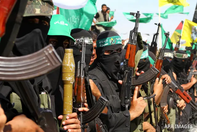 Hamas militants stand guard near Rafah Crossing through which Palestinian prisoners going to be freed in a prisoner swap between Hamas and Israel will enter the Gaza Strip on 18 October 2011 As Gilad Shalit, the Israeli...