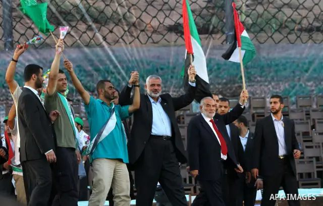Palestinian Prime Minister in Gaza Strip, Ismail Haniyeh stands with released Palestinian prisoner among others as they celebrate during a welcoming ceremony, in Gaza City, Tuesday, Oct. 18, 2011. Hamas agreed to release...