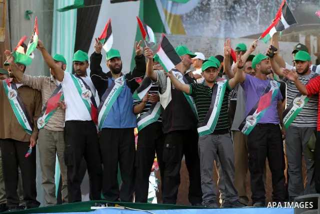 Palestinian Prime Minister in Gaza Strip, Ismail Haniyeh stands with released Palestinian prisoner among others as they celebrate during a welcoming ceremony, in Gaza City, Tuesday, Oct. 18, 2011. Hamas agreed to release...
