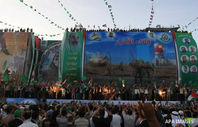 Palestinian Prime Minister in Gaza Strip, Ismail Haniyeh stands with released Palestinian prisoner among others as they celebrate during a welcoming ceremony, in Gaza City, Tuesday, Oct. 18, 2011. Hamas agreed to release...