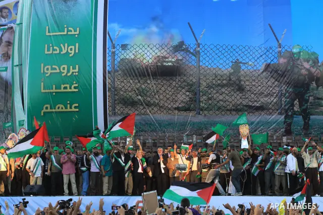 Palestinian Prime Minister in Gaza Strip, Ismail Haniyeh stands with released Palestinian prisoner among others as they celebrate during a welcoming ceremony, in Gaza City, Tuesday, Oct. 18, 2011. Hamas agreed to release...