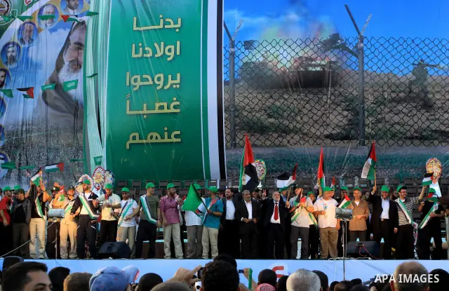 Palestinian Prime Minister in Gaza Strip, Ismail Haniyeh stands with released Palestinian prisoner among others as they celebrate during a welcoming ceremony, in Gaza City, Tuesday, Oct. 18, 2011. Hamas agreed to release...