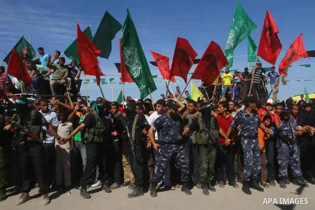 Hamas militants stand guard near Rafah Crossing through which Palestinian prisoners going to be freed in a prisoner swap between Hamas and Israel will enter the Gaza Strip on 18 October 2011 As Gilad Shalit, the Israeli...
