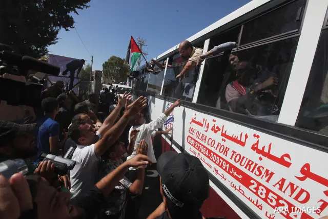 Palestinian prisoners cross to the southern Gaza Strip from the Egyptian side of the Rafah border on Oct. 18, 2011 upon their release from Israeli prisons under a landmark deal to free abducted Israeli soldier Gilad Shal...