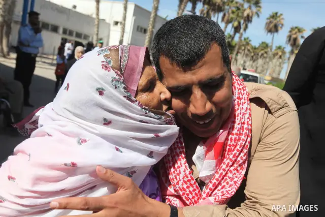 Palestinians greet their relative released Palestinian prisoner at the Rafah border crossing in southern Gaza Strip, Tuesday, Oct. 18, 2011. The Hamas militant group released an Israeli soldier Tuesday more than five yea...