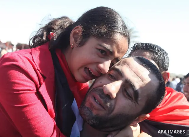 Palestinians greet their relative released Palestinian prisoner at the Rafah border crossing in southern Gaza Strip, Tuesday, Oct. 18, 2011. The Hamas militant group released an Israeli soldier Tuesday more than five yea...