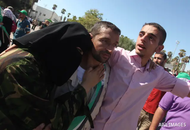 Palestinians greet their relative released Palestinian prisoner at the Rafah border crossing in southern Gaza Strip, Tuesday, Oct. 18, 2011. The Hamas militant group released an Israeli soldier Tuesday more than five yea...