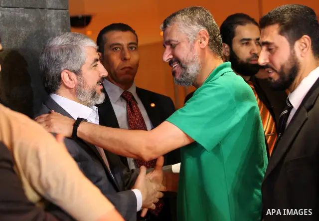 Exiled Palestinian Hamas leader Khaled Meshaal meets with some 40 Palestinian prisoners who were freed by Israel but are to be deported overseas, in Cairo on October 18, 2011. Israeli soldier Gilad Shalit was released in...