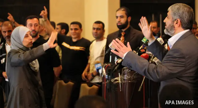 Exiled Palestinian Hamas leader Khaled Meshaal addresses a meeting with some 40 Palestinian prisoners who were freed by Israel but are to be deported overseas, in Cairo on October 18, 2011. Israeli soldier Gilad Shalit w...