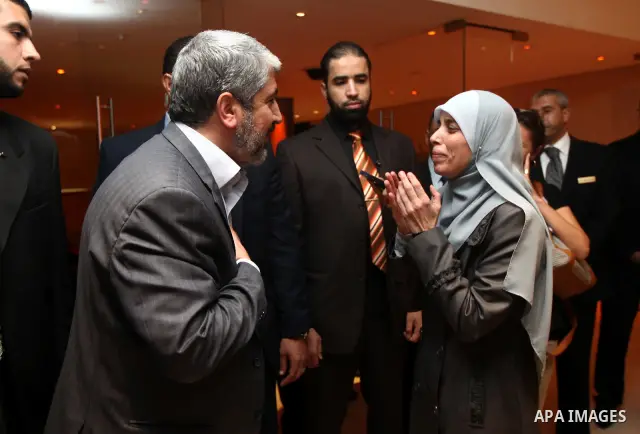 Exiled Palestinian Hamas leader Khaled Meshaal meets with some 40 Palestinian prisoners who were freed by Israel but are to be deported overseas, in Cairo on October 18, 2011. Israeli soldier Gilad Shalit was released in...