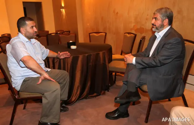Exiled Palestinian Hamas leader Khaled Meshaal meets with Hamas militant leader Ahmed al-Jabari, in Cairo on October 18, 2011. Israeli soldier Gilad Shalit was released in a landmark deal which also saw 477 Palestinian d...