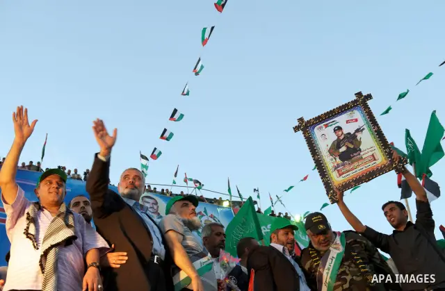 Palestinian Prime Minister in Gaza Strip, Ismail Haniyeh stands with released Palestinian prisoner among others as they celebrate during a welcoming ceremony, in Gaza City, Tuesday, Oct. 18, 2011. Hamas agreed to release...