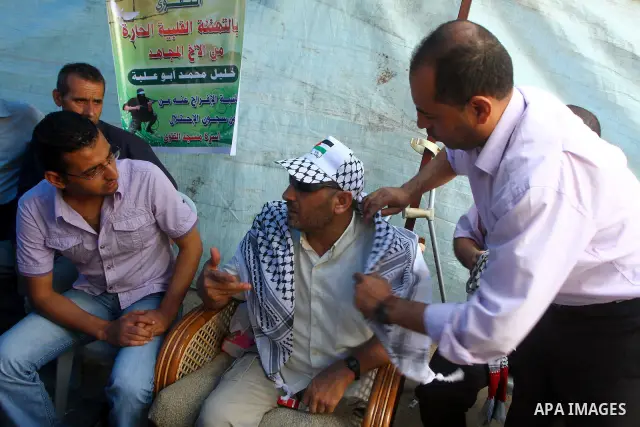 Freed Palestinian prisoner Khalil Abu Ulba sits with his relatives and friends after his release from an Israeli jail, in Gaza city on October 19, 2011. Israeli soldier Gilad Shalit and hundreds of Palestinians crossed I...