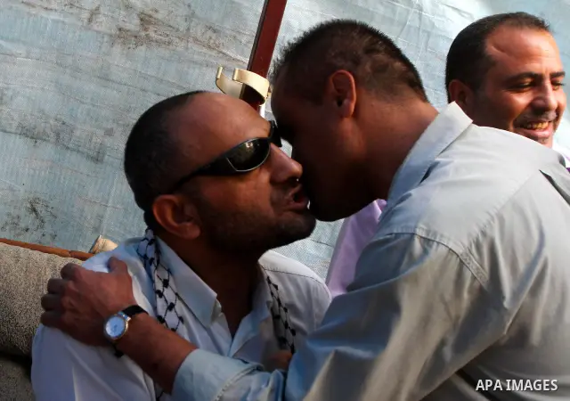 Freed Palestinian prisoner Khalil Abu Ulba sits with his relatives and friends after his release from an Israeli jail, in Gaza city on October 19, 2011. Israeli soldier Gilad Shalit and hundreds of Palestinians crossed I...