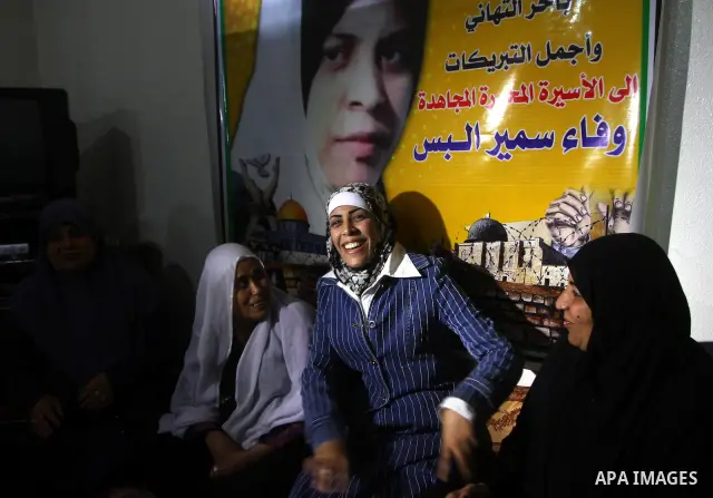 Freed Palestinian prisoner Wafa Albes smiles as she sits near her relatives after her release from an Israeli jail on October 19, 2011 in the Jabalia refugee camp. Wafa has been jailed in Israel since 2005. The Palestini...