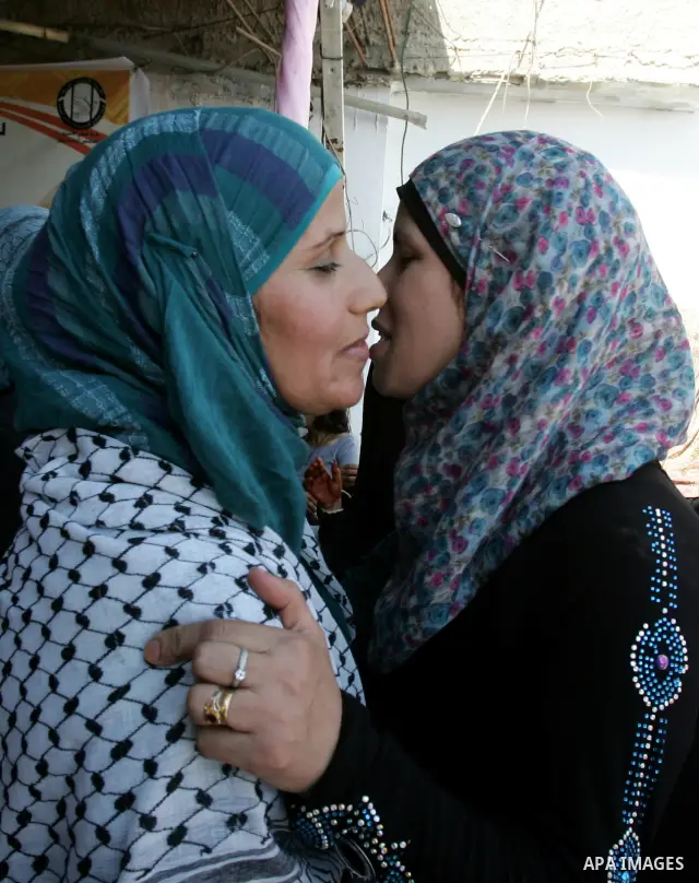 Freed Palestinian prisoner Ibtisam Esawi is greeted by relatives and friends after her release from an Israeli jail in the East Jerusalem neighbourhood of Jabal al-Mukaber on October 19, 2011. The Palestinian Hamas movem...