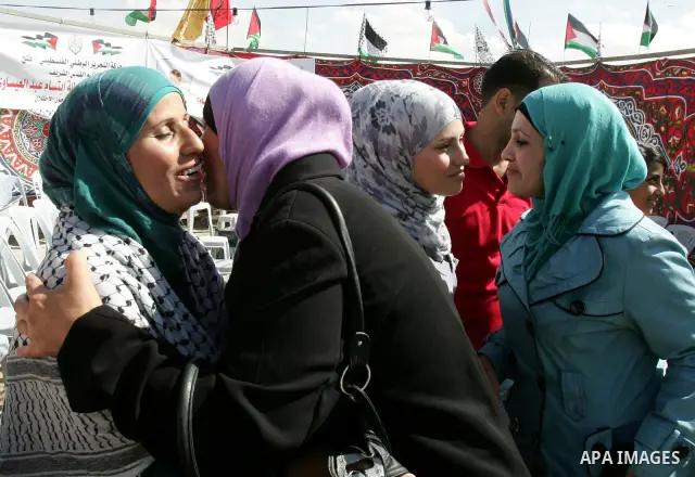 Freed Palestinian prisoner Ibtisam Esawi is greeted by relatives and friends after her release from an Israeli jail in the East Jerusalem neighbourhood of Jabal al-Mukaber on October 19, 2011. The Palestinian Hamas movem...