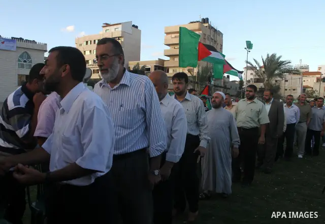 Palestinians shake hands as they visit the tent erected to welcome Palestinian prisoners released in exchange for the captured Israeli soldier Gilad Schalit in Gaza City, Wednesday, Oct. 19, 2011. Photo by Ashraf Amra