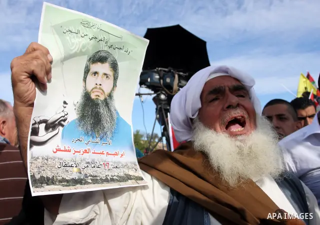 Palestinians wait at the Beituniya checkpoint for released Palestinian prisoners to cross into the West Bank city of Ramallah, Tuesday, Oct. 18, 2011. The Hamas militant group released an Israeli soldier Tuesday more tha...