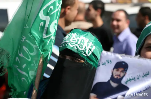Palestinians wait at the Beituniya checkpoint for released Palestinian prisoners to cross into the West Bank city of Ramallah, Tuesday, Oct. 18, 2011. The Hamas militant group released an Israeli soldier Tuesday more tha...