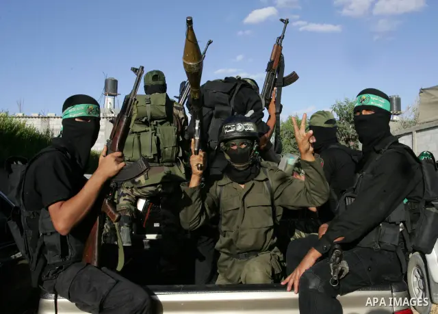 Hamas militants patrol during their visit to the freed Palestinian prisoners in Rafah in southern Gaza Strip October 19, 2011. Palestinians freed by Israel in a trade for soldier Gilad Shalit took their morning exercise...