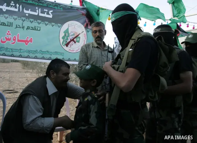 Hamas militants visit a freed Palestinian prisoner in Rafah in southern Gaza Strip October 19, 2011. Palestinians freed by Israel in a trade for soldier Gilad Shalit took their morning exercise on Wednesday around a luxu...