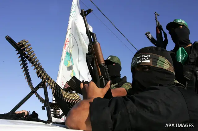 Hamas militants patrol during their visit to the freed Palestinian prisoners in Rafah in southern Gaza Strip October 19, 2011. Palestinians freed by Israel in a trade for soldier Gilad Shalit took their morning exercise...
