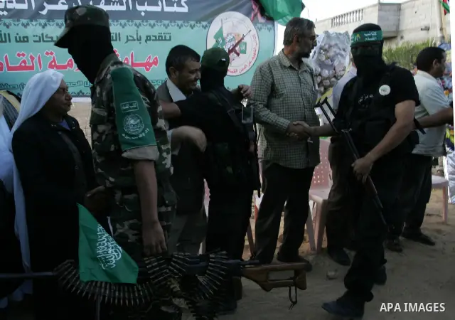 Hamas militants visit a freed Palestinian prisoner in Rafah in southern Gaza Strip October 19, 2011. Palestinians freed by Israel in a trade for soldier Gilad Shalit took their morning exercise on Wednesday around a luxu...