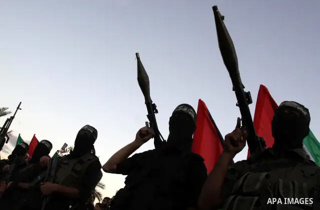 Palestinian Hamas militants stand guard outside the tent erected to welcome Palestinian prisoners released in exchange for the captured Israeli soldier Gilad Schalit in Gaza City, Wednesday, Oct. 19, 2011. Photo by Moham...
