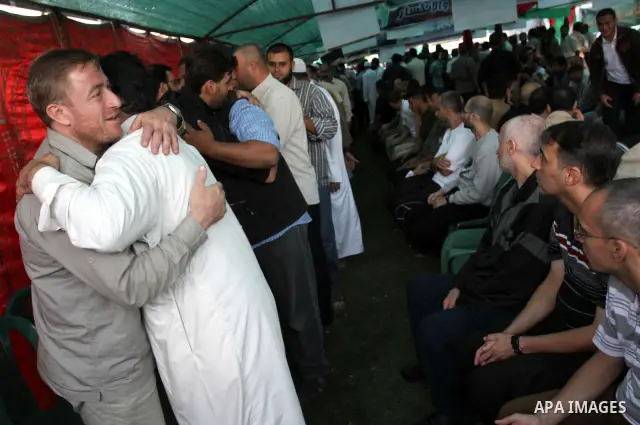Palestinians shake hands as they visit the tent erected to welcome Palestinian prisoners released in exchange for the captured Israeli soldier Gilad Schalit in Gaza City, Wednesday, Oct. 19, 2011. Photo by Mohammed Asad