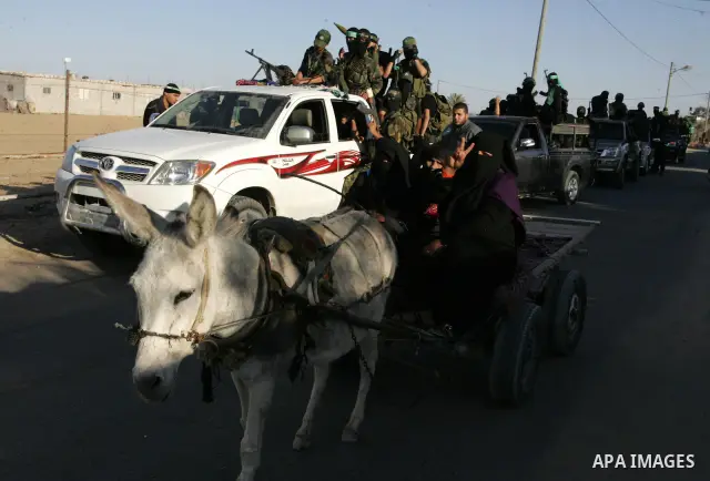 Hamas militants visit a freed Palestinian prisoner in Rafah in southern Gaza Strip October 19, 2011. Palestinians freed by Israel in a trade for soldier Gilad Shalit took their morning exercise on Wednesday around a luxu...
