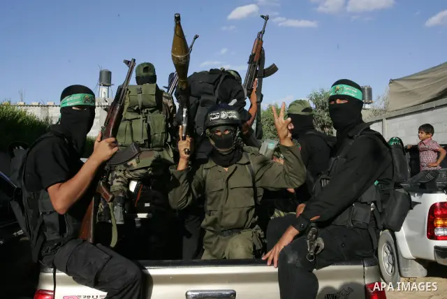 Hamas militants visit a freed Palestinian prisoner in Rafah in southern Gaza Strip October 19, 2011. Palestinians freed by Israel in a trade for soldier Gilad Shalit took their morning exercise on Wednesday around a luxu...